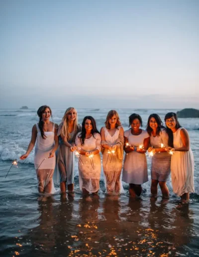 a group of women standing on top of a beach.